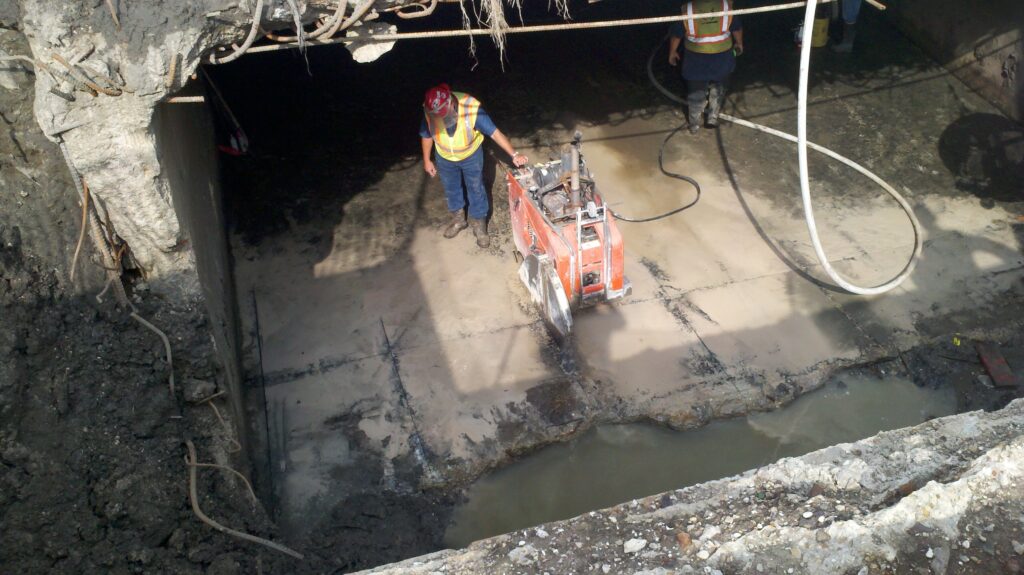 A worker saw cutting at The Pump Station No. 5's base slab in Orleans Parish, Louisiana